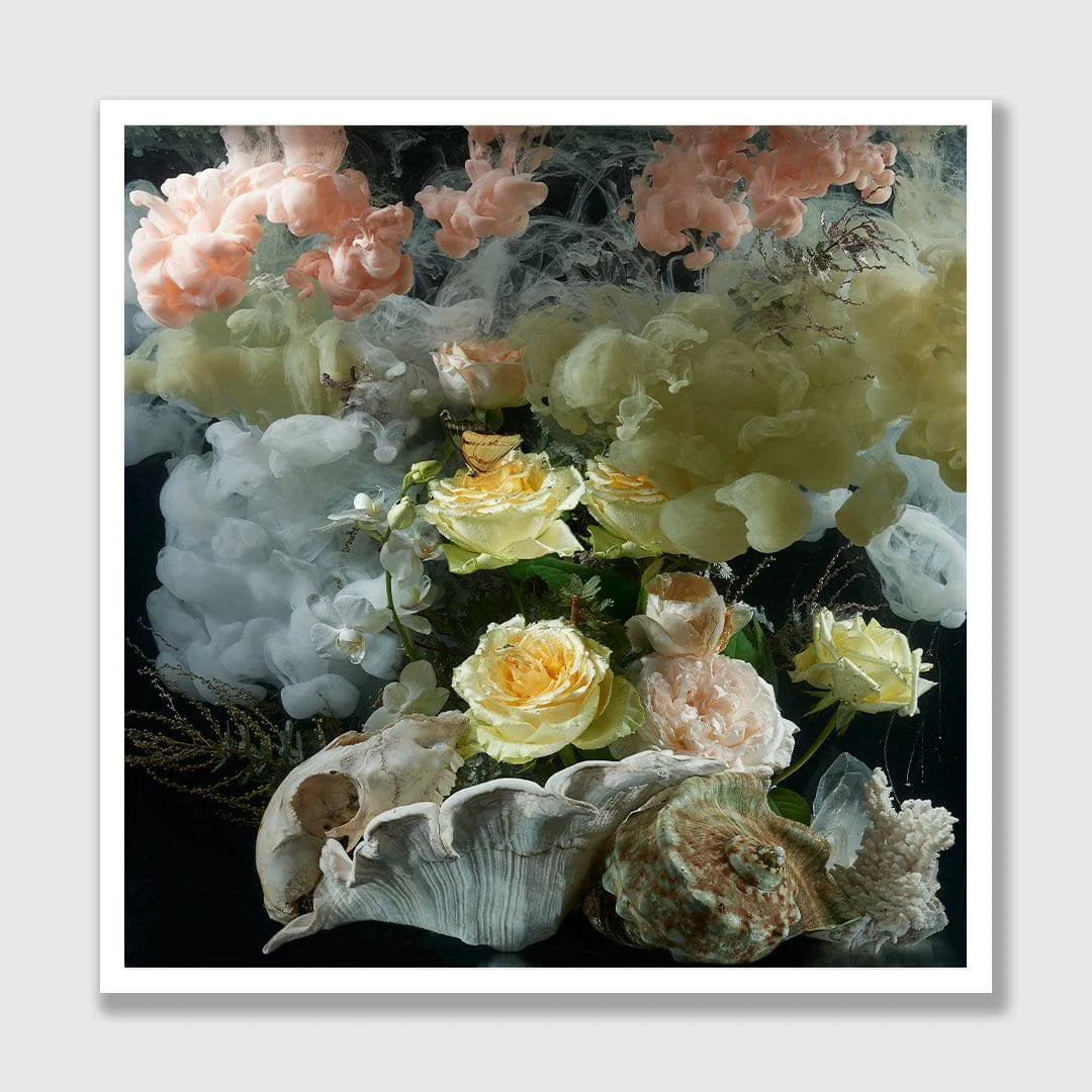 A square art print featuring a surreal still life of soft pink, yellow, and white flowers blending into textured white clouds, with seashells resting at the bottom, presented on a light gray background with a white border.