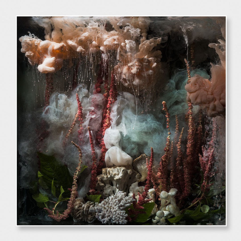An abstract, painterly composition with smoky peach, gray, and teal forms, red vertical spires, white sculptural elements, and dark shadowy areas, presented as wall art with a thin white border.